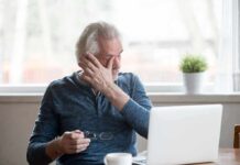 Outrageously Simple Fixes That Beat Daily Fatigue Older man rubbing his eye while sitting at a laptop