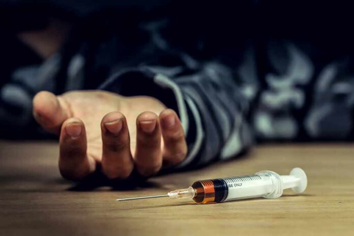 Syringe on table near an outstretched hand
