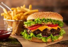 Study Reveals How Specific Foods Impact Life Expectancy Cheeseburger with fries on rustic surface