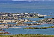 What if rising seas wipe nations off the map? Aerial view of a coastal landscape featuring waterways and islands