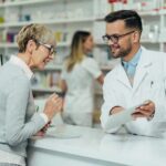 Pharmacist assists customer at pharmacy counter