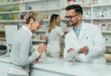 Uninsured Surge Triggers ER Shock — Guess Who Pays Pharmacist assists customer at pharmacy counter