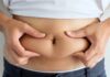 Belly Fat Twist: Estrogen Flips The Script person pinching belly fat at the waist