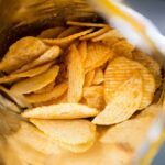 Ridged potato chips inside an open bag