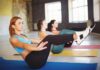 Seated Exercises That Help Slash Blood Sugar Women practicing boat pose on yoga mats in a studio