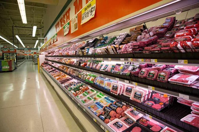 shutterstock_1070248184 Grocery store meat aisle stocked with packaged beef and poultry