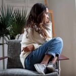 Depression’s Hidden Clock Subtype Emerges Woman sitting curled up on a chair looking out a window