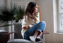 Depression’s Hidden Clock Subtype Emerges Woman sitting curled up on a chair looking out a window