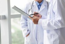 Benefits of Prescribing Food As Medicine Doctors reviewing a clipboard