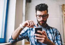 Heavy Scrolling, Alarming Brain Red Flags Man using smartphone by a window