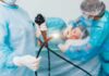 Young Bodies, Old Cancer Medical staff preparing endoscope near patient on hospital bed