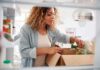 Fast Food Hangover Tied To Darker Minds Woman unpacking groceries into a refrigerator