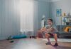 Man doing bodyweight squats in a living room