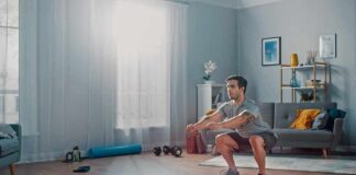 Man doing bodyweight squats in a living room