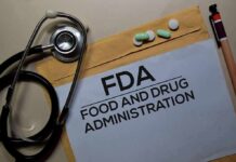 FDA document with stethoscope, pills, and pencil on envelope