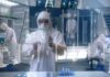 Mayo Builds ‘Smelling’ ER – What It Catches Scientist in hazmat suit using a transparent digital tablet in a lab