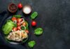 Low-Effort Ways To Make Any Meal More Nutritious In Minutes Grilled chicken salad with avocado, tomatoes, and spinach on a dark plate