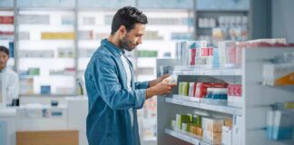 Man shopping in a pharmacy aisle