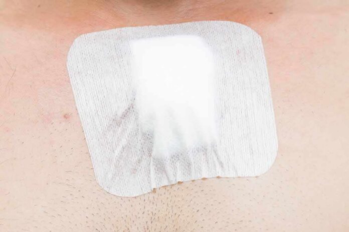 shutterstock_283626134 adhesive bandage on chest