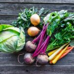 Assorted fresh vegetables on wooden table