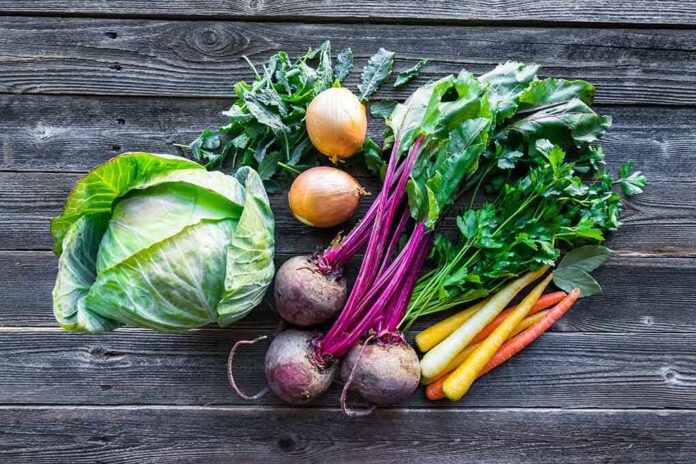 Assorted fresh vegetables on wooden table
