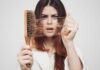 Weight-Melt Trend, Hair Fallout Woman holding a hairbrush with clumps of hair