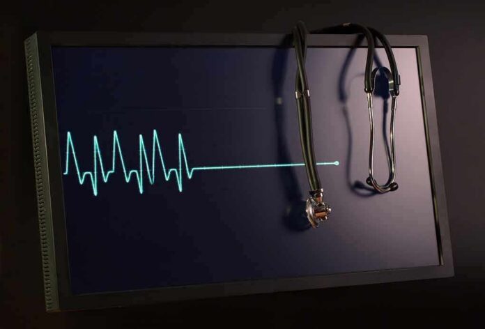 stethoscope hanging on monitor with flatlined ecg