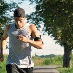 Man running on a tree-lined path