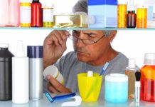 Millions Duped by Popular Prostate Supplement Man reading a pill bottle in a bathroom cabinet